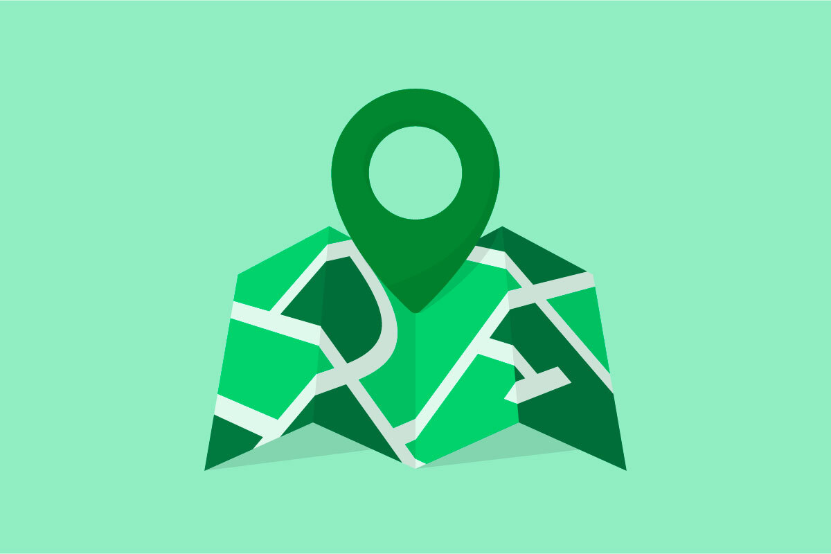 An unfolded map with a pin on a light green background.