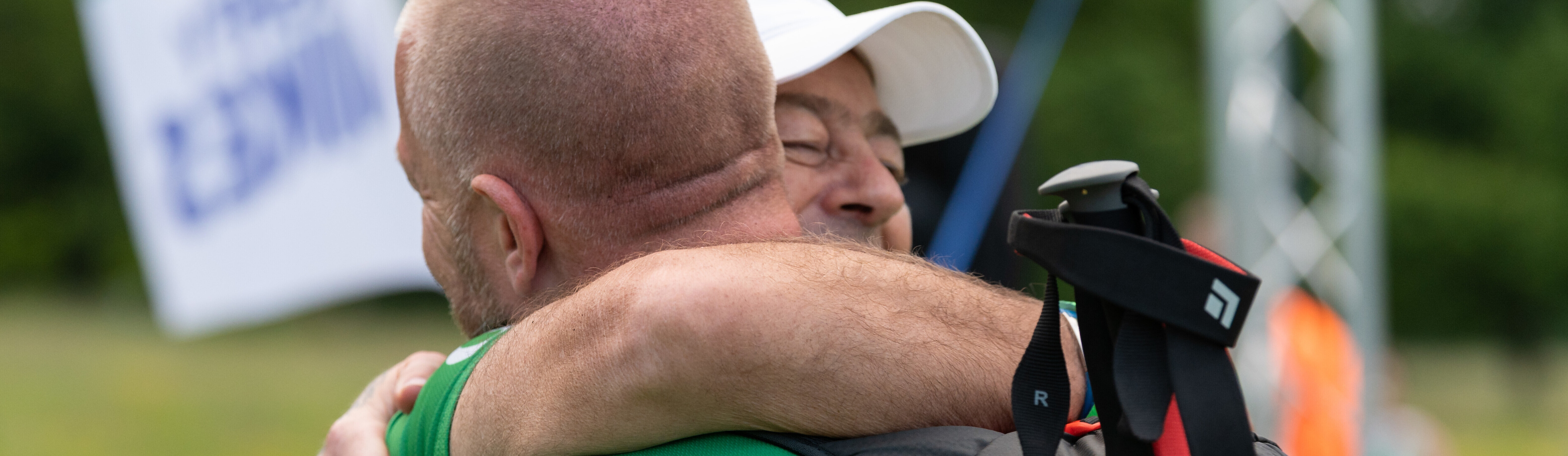 Two men on a hike hugging