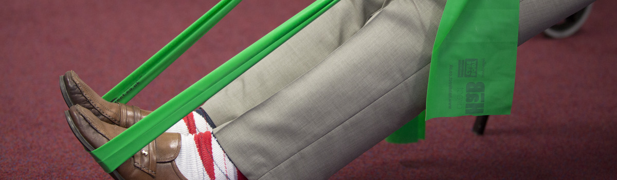 A man using a green resistance band