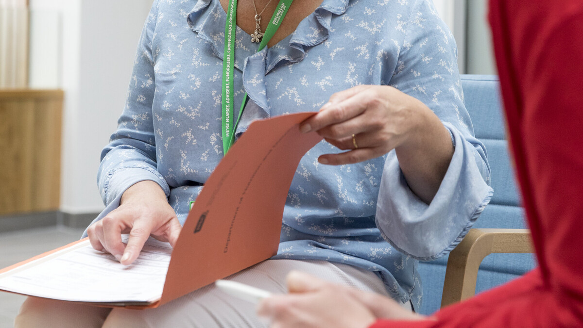 Two women looking at a folder