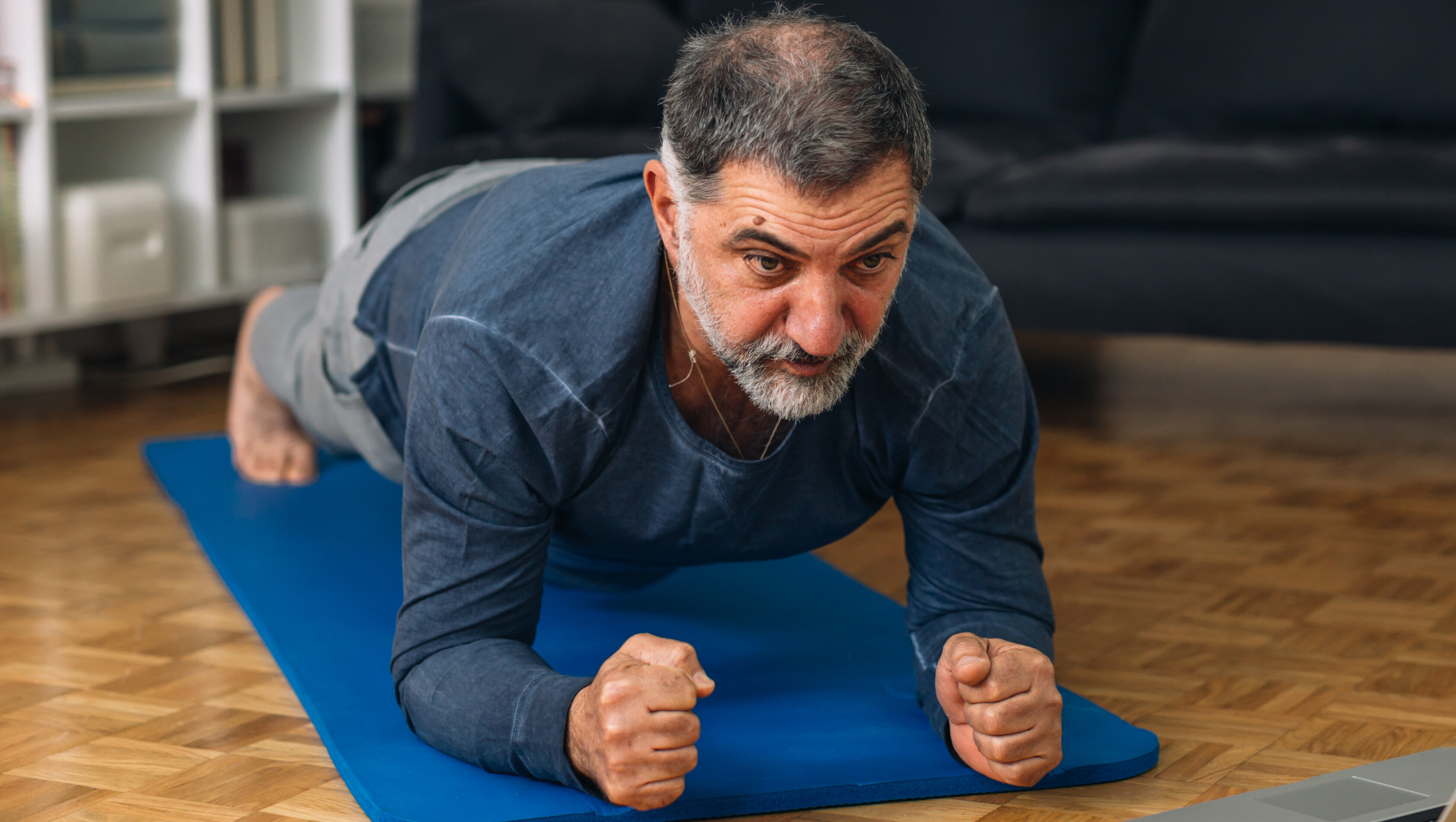 An Asian man doing a plank