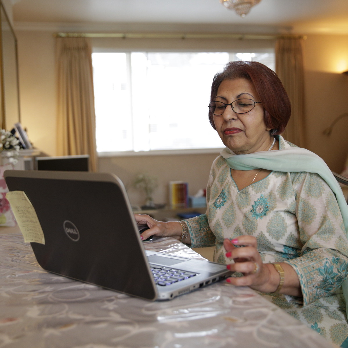Woman with laptop sitting at a table