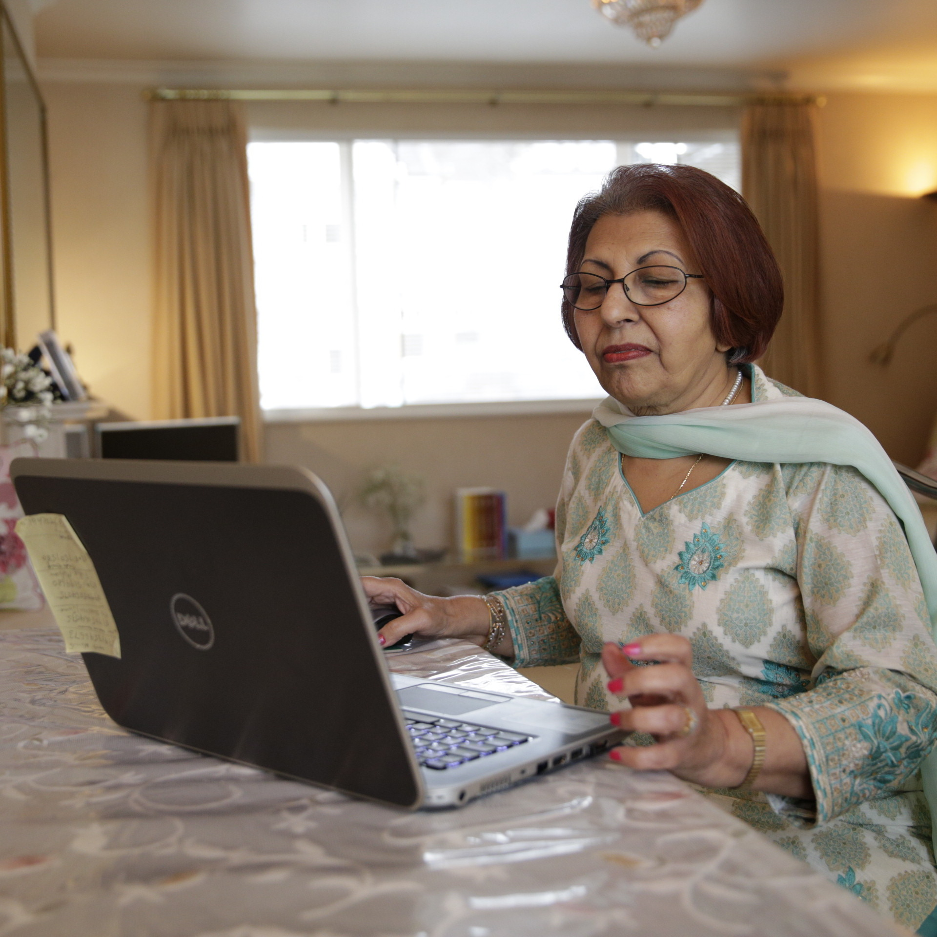 Woman with laptop sitting at a table