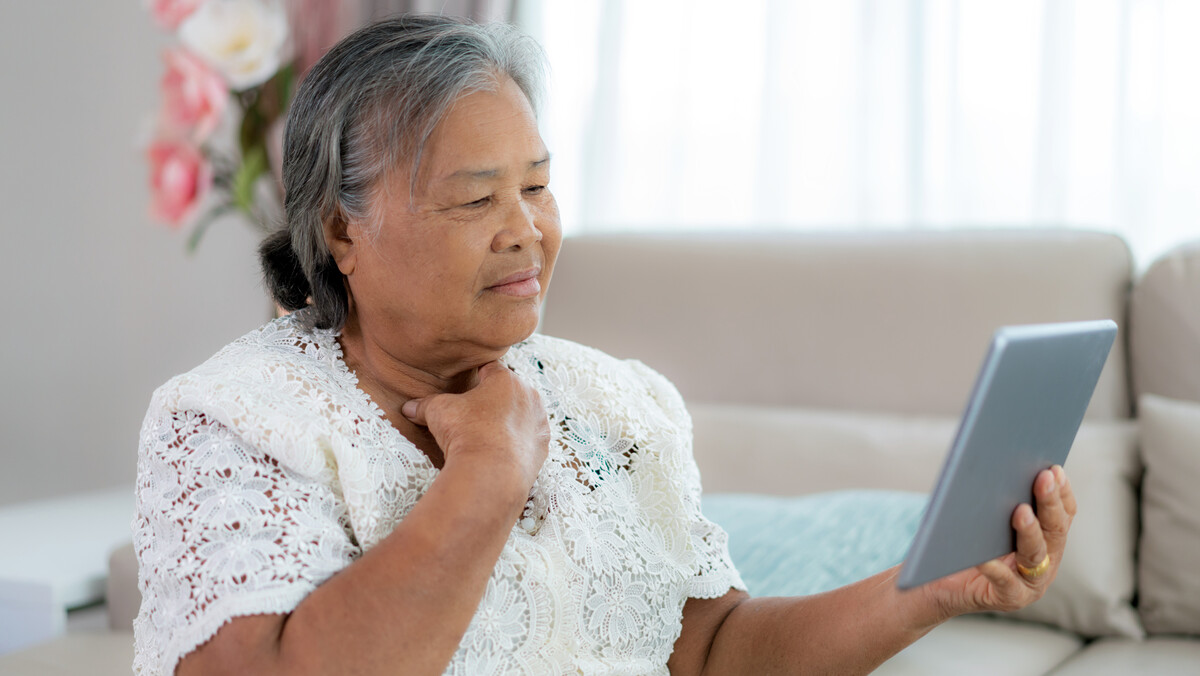Asian woman looking at a tablet