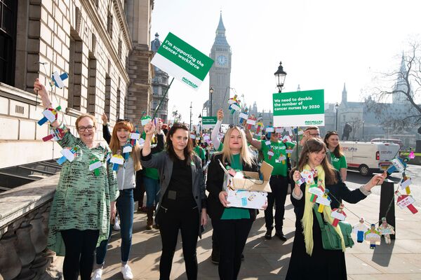 Macmillan campaigners stood in the street holding signs