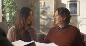 A couple look at eachother smiling.