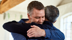 Two men hugging