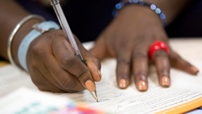 A lady completes financial forms.